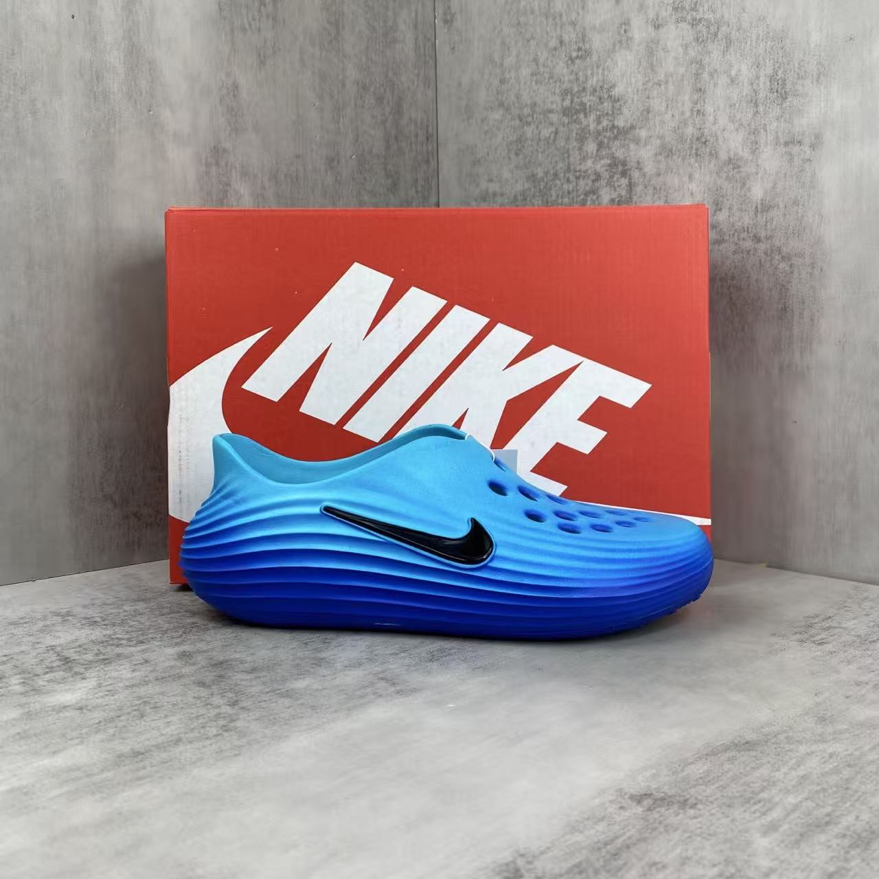 Nike ReactX Rejuvenation Slides in Blue: Aqua-Coded Recovery