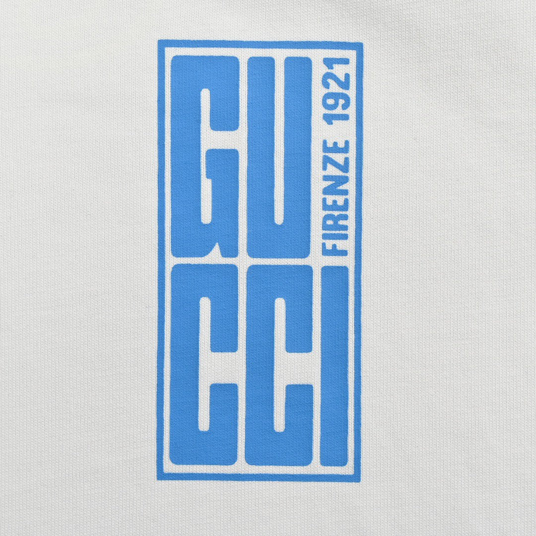 G*u*i white t-shirt with blue vertical logo patch