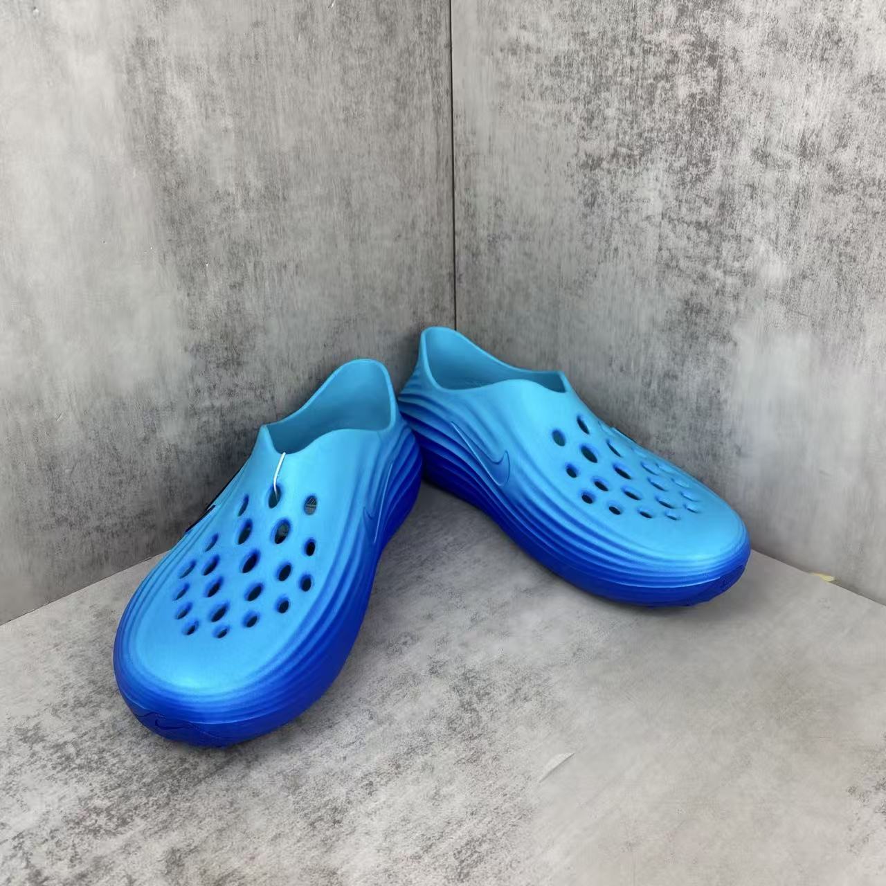 Nike ReactX Rejuvenation Slides in Blue: Aqua-Coded Recovery