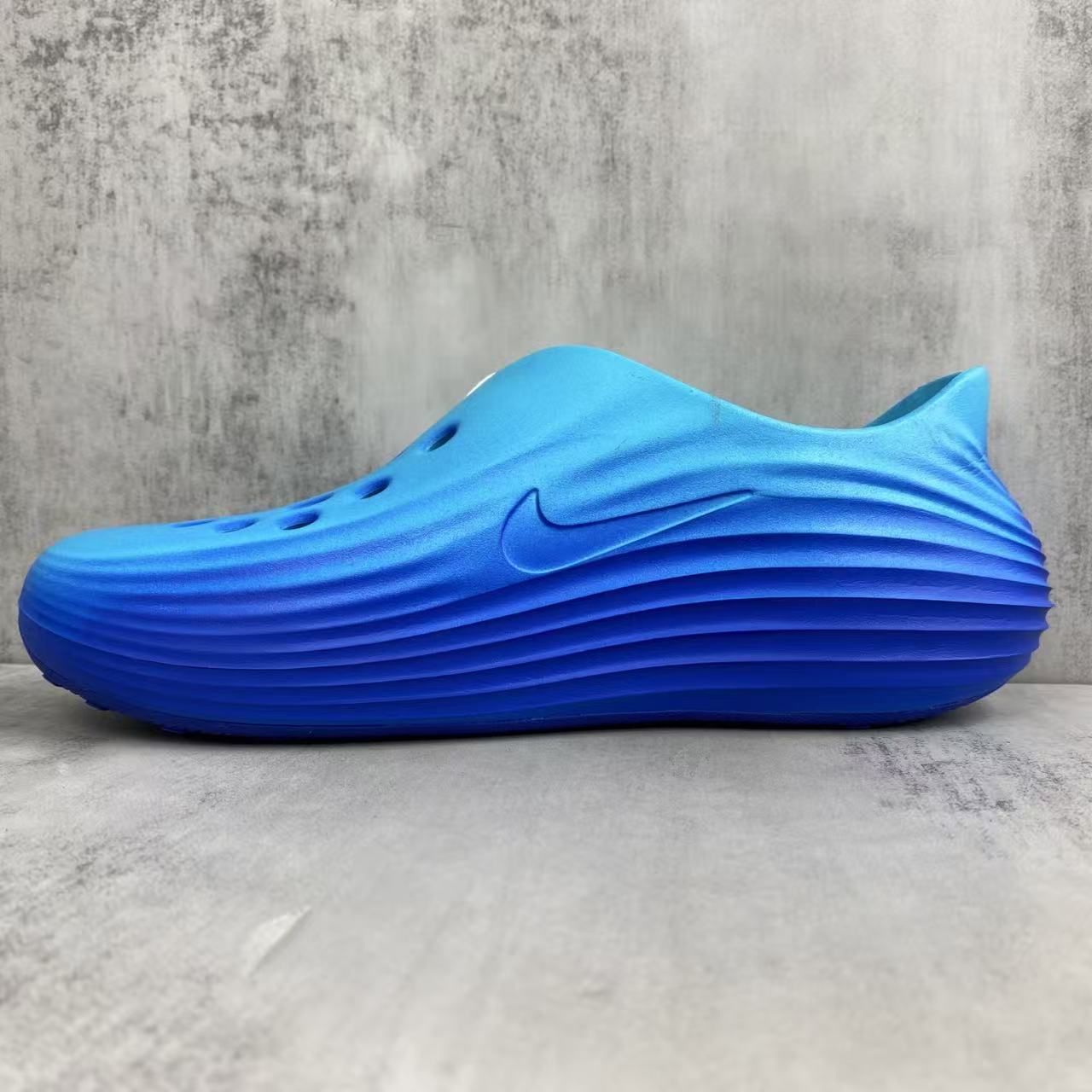 Nike ReactX Rejuvenation Slides in Blue: Aqua-Coded Recovery
